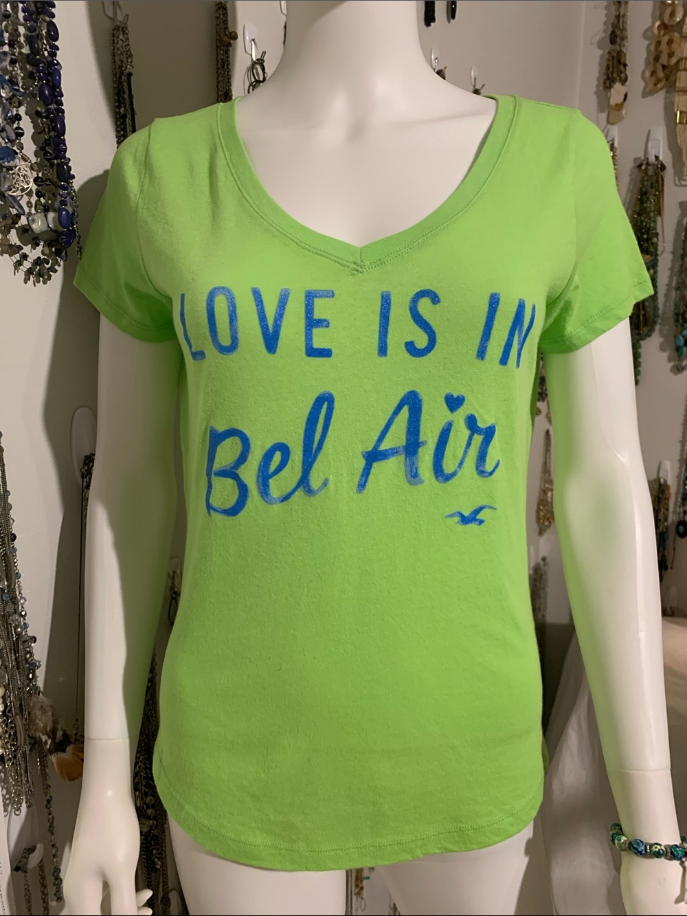 Hollister Lime Green V-Neck Graphic Tee with Blue Lettering with bracelet